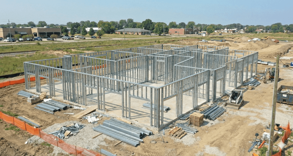 Wall panel erection — ZAM180 C-studs fastened to tracks.